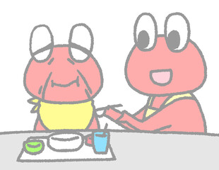 食事を介助するカエルと介助される老カエル（赤色）