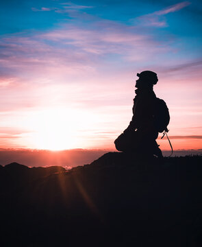 silhouette of person knee pray landscape sunrise in mountain 