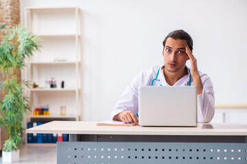 Young male doctor in telemedicine concept