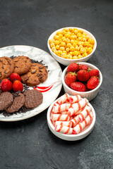 front view yummy choco biscuits with candies on the dark background cake sweet cookie sugar