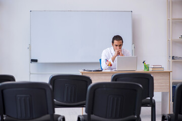 Young male doctor giving seminar in the classroom