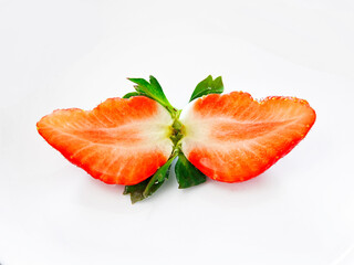 2020: Fresh and juicy sliced strawberry on white background
