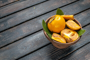 front view fresh sweet persimmons on the wooden rustic desk mellow fruit tree health