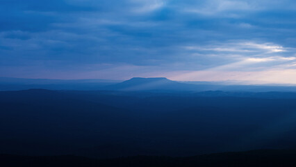 Fototapeta premium dramatic sunset sunset sky wide and high mountain landscape Pha Yieb Mek in Phu Kradueng National park. Thailand