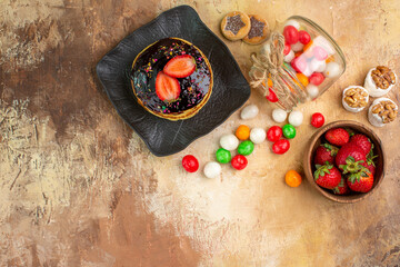 top view sweet pancakes with colorful candies on a wooden desk cake dessert sweet pie