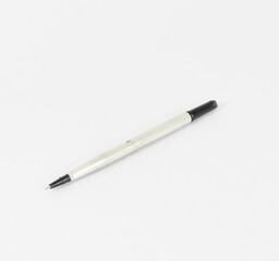 A black ink pen that is the handle of a pen on a white background