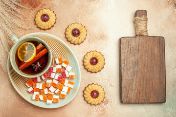 top view little cookies with cup of tea on brown desk biscuit sweet cake dessert