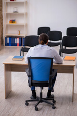 Young male boss giving seminar in the office during pandemic