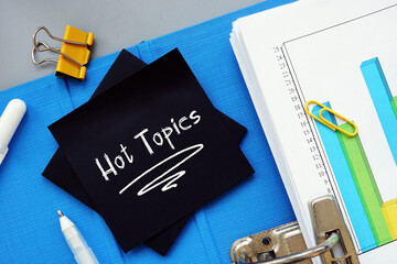 Financial concept about Hot Topics  with inscription on the piece of paper.