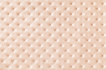 Texture of pearl beige leather background with capitone pattern, macro.