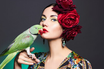 beautiful young woman with parrot and floral hat