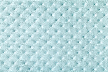Texture of light blue leather background with capitone pattern, macro.