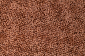 Brown fluffy background of soft, velour fabric. Texture of umber wool textile.