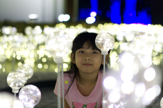 Portrait Asian cute little girl hold Decorative Light bulb