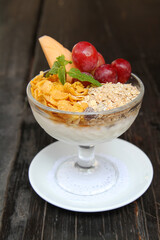 Breakfast, cereals served with yogurt,grapes and papaya