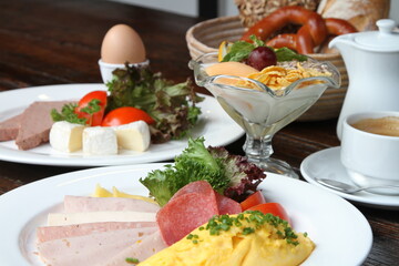 Breakfast table with different German breakfasts and coffee and tea
