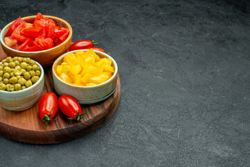 side close view of vegetables on plate stand with free space for your text on dark grey background