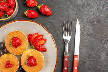 top view little yummy pancakes with fruits on the dark-grey background pie cake fruit