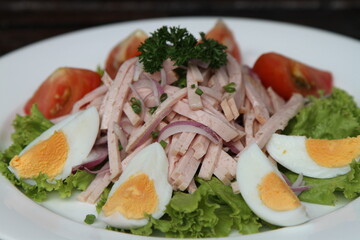 Swiss sausage salad served with boiled eggs