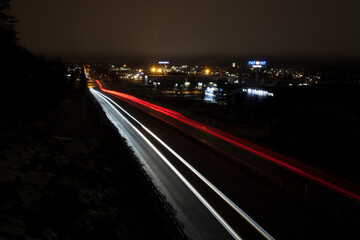 Umea, Norrland Sweden - December 7, 2020: light trails from cars by a bridge at Ersboda