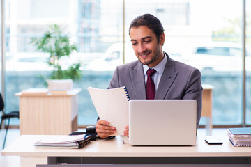 Young male employee working in the office