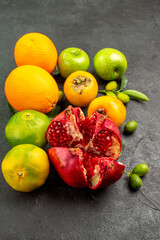front view fresh pomegranate with apples and other fruits on dark background ripe fruit color