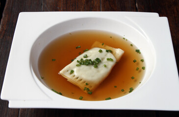 Beef consomme with veal ravioli