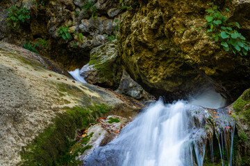 Long exposure waterfall over brown and green rocks