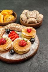 front view yummy pancakes with fruits and sweet cakes on the dark background sweet cake dessert