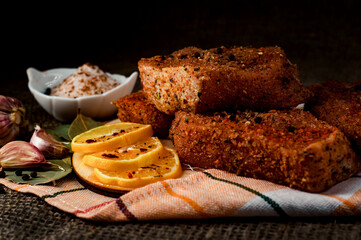 Pieces of salted meat with lemon, garlic and spices. Cooking a meat dish