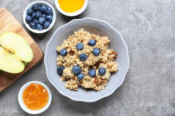 Bowl with tasty sweet oatmeal on table