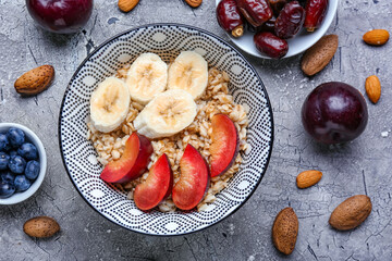 Bowl with tasty sweet oatmeal on table