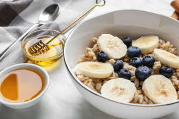 Bowl with tasty sweet oatmeal, closeup