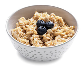 Bowl with tasty sweet oatmeal on white background