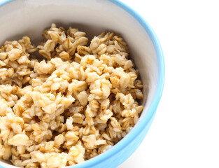 Bowl with tasty oatmeal on white background