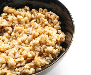 Bowl with tasty oatmeal on white background