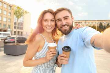 Young couple taking selfie outdoors