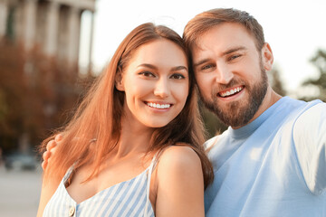 Young couple taking selfie outdoors