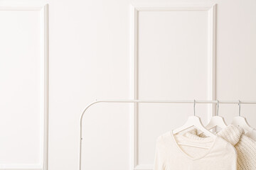 Rack with clothes on white background
