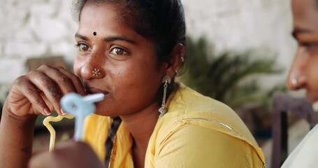 Slow-motion close-up shots of two females outside for chilling and having a cocktail drink together as best friends lovers after work