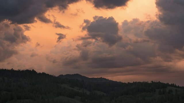 Timelapse of Grand Teton National Parks' famous Gross Venture Mountains with clouds passing through durning sunset creating a bunch of beautiful light. 