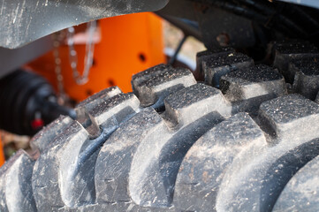 the dirty rubber tire of a bulldozer