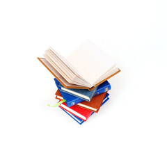 Stack of books in colour covers with white sheets isolated on a white background