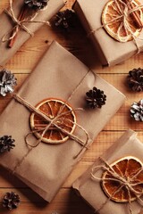 Gifts for Christmas and New Year. packed craft gifts with cinnamon and orange for decoration.