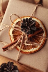 Gifts for Christmas and New Year. packed craft gifts with cinnamon and orange for decoration.
