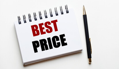 On a light background, a white notebook with the words BEST PRICE and a pen.