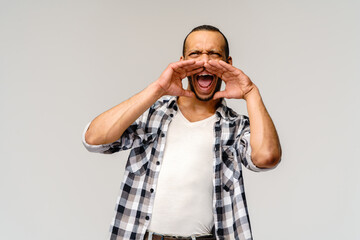 young african american man shouting against a grey background