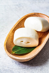 Chinese steamed rice roll bun on wooden plate. Chinese food concept.