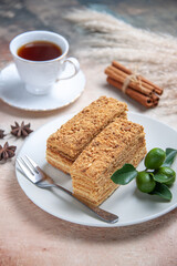 front view cake slices honey cake with cup of tea on light background sweet pie biscuit cake