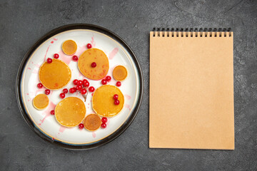 top view yummy little pancakes with red berries on grey floor fruit dessert sweet